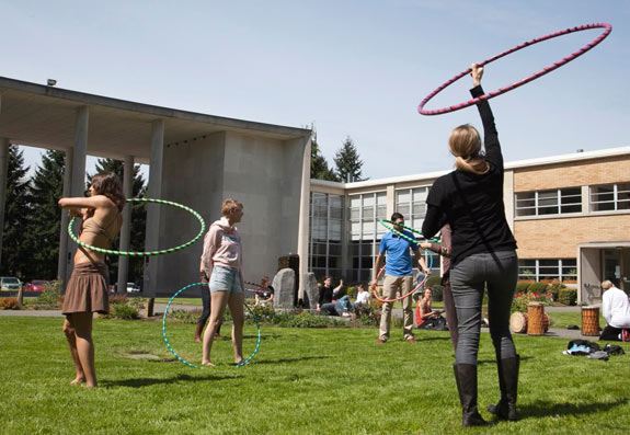 people with hula hoops in bastyr courtyard