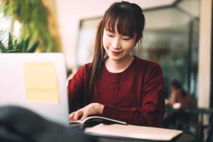 person working at laptop computer smiling