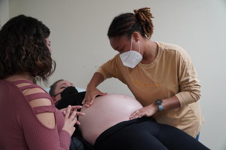 midwives examining a pregnant person
