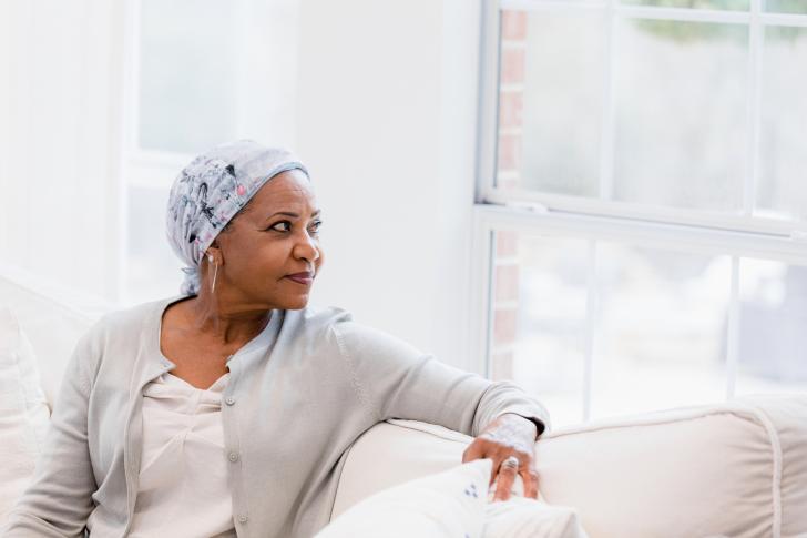 woman with cancer looking peacefully out window