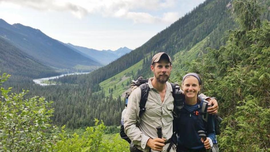 two people standing in a valley