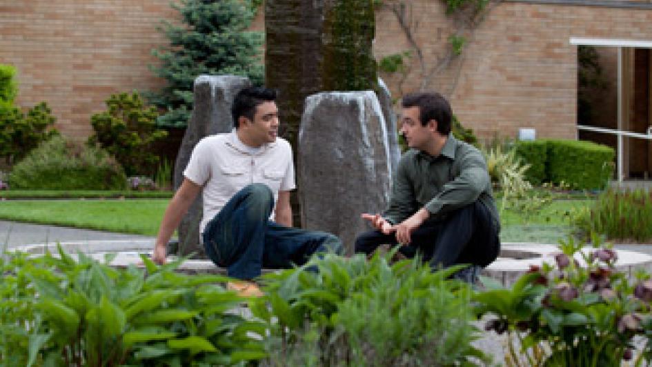 two people sitting in bastyr courtyard
