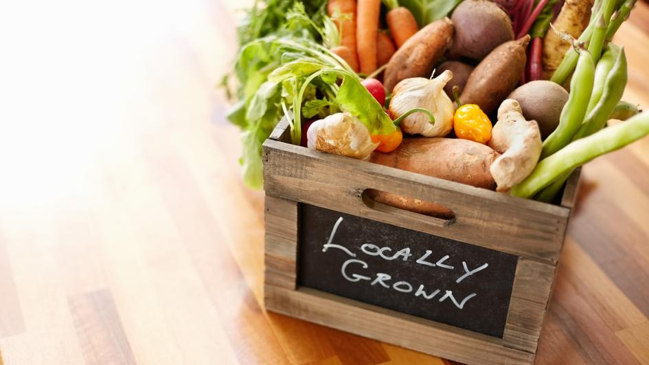 box of fruit labeled "locally grown"