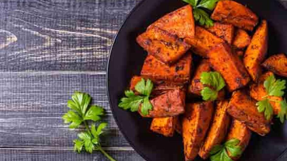 bowl of sweet potatoes and parsely garnish