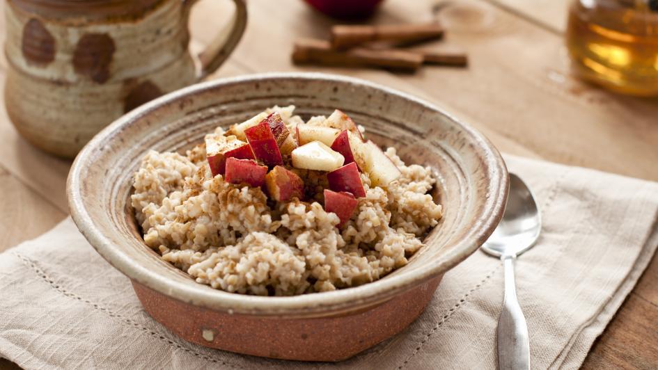 Breakfast made of oatmeal with apples, honey and cinnamon