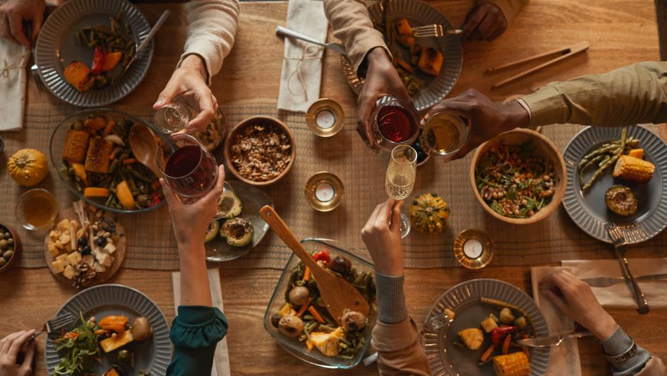 overhead view of 5 people sitting at a table full of food