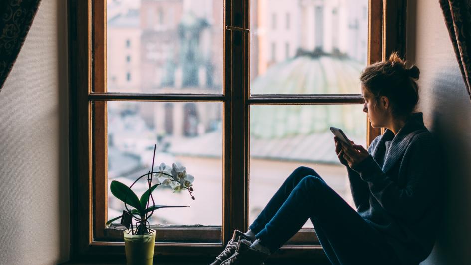 person sitting looking out a window