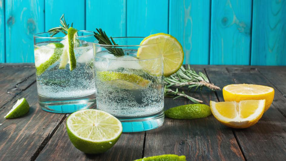 two glasses of sparkling water with limes and lemons