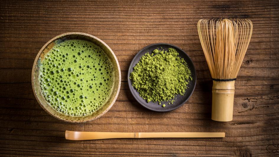 two bowls of dry matcha and wet matcha with whisk and spoon