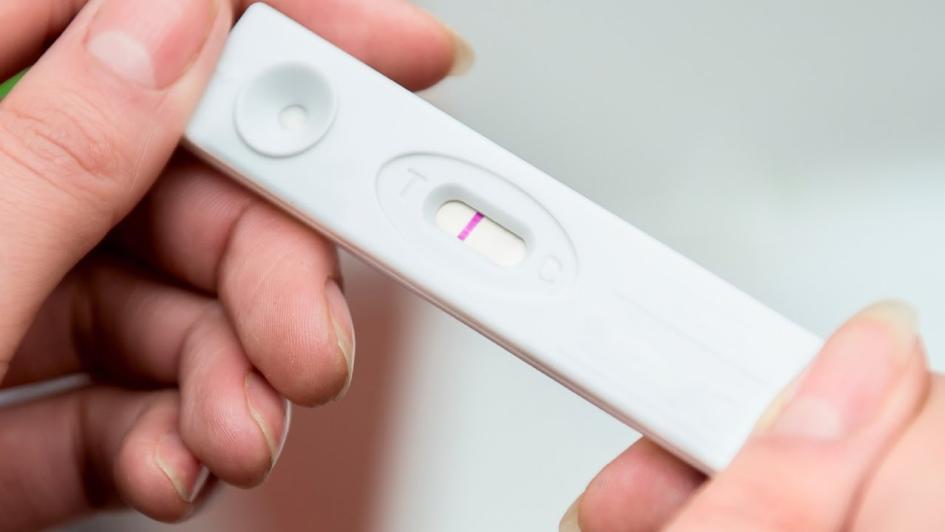 person holding positive pregnancy test