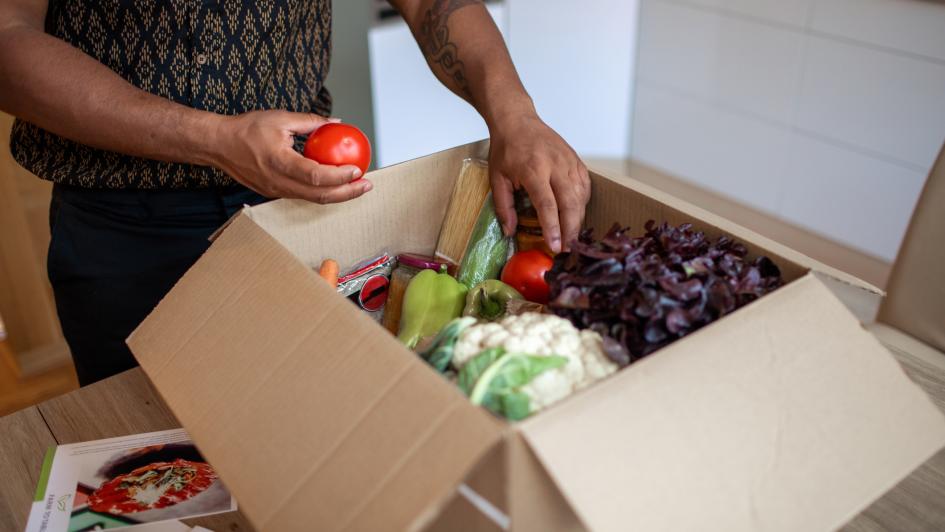 person pulling food out of a box