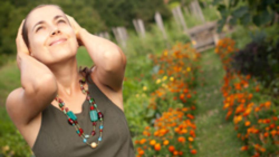 person in garden with hands behind their head