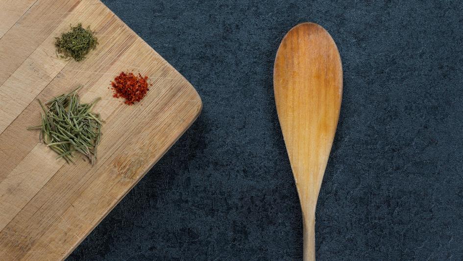 wooden spoon and cutting board with spices 