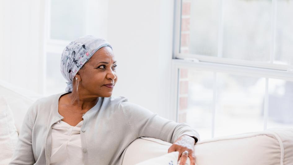 woman with cancer looking peacefully out window