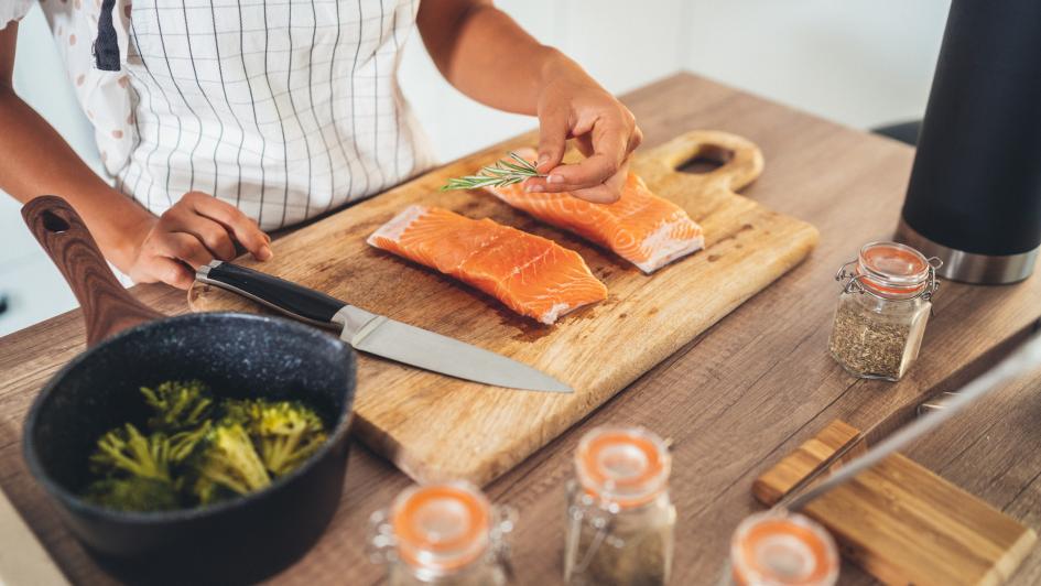 person preparing salmon